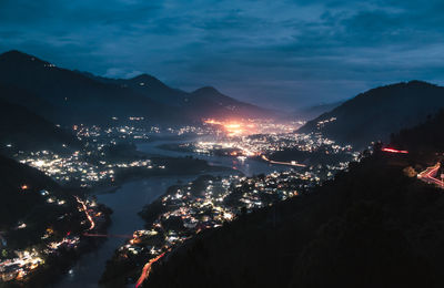 High angle view of illuminated cityscape against sky at night