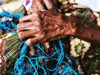 Cropped hand of woman holding rope