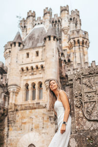 Woman standing at historical building