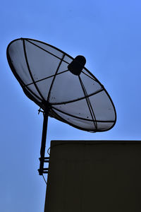 Low angle view of silhouette smart phone against clear sky