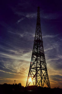 Low angle view of silhouette tower against sky during sunset