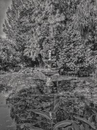 Digital composite image of statue and trees in park