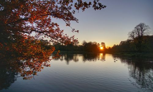 Scenic view of lake against sky during sunset