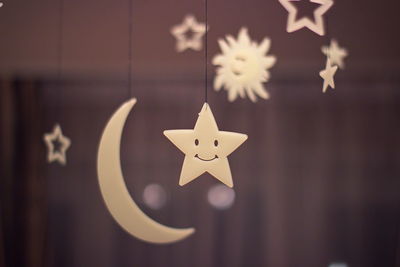 Close-up of christmas decoration hanging against wall