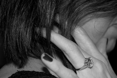 Close-up of young woman with hand in hair