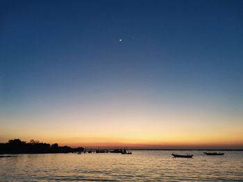 Scenic view of sea against clear sky during sunset