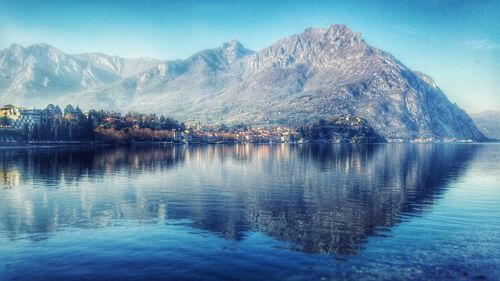 Scenic view of lake and mountains against sky