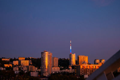 Buildings in city against blue sky