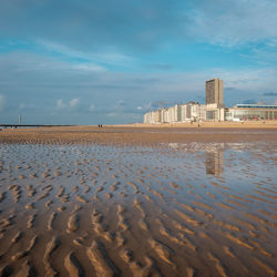 Scenic view of sea against sky in city