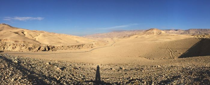 Scenic view of arid landscape against sky