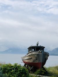 Ship moored on sea against sky