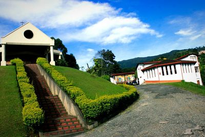 View of house against cloudy sky