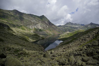 Scenic view of lake and mountains against sky