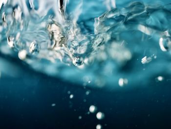 Full frame shot of blue wave splashing swimming pool