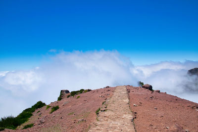 Scenic view of mountain against blue sky