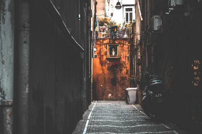 Narrow street amidst buildings in city