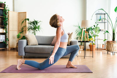 Side view of woman exercising in gym