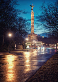Statue of illuminated city at night