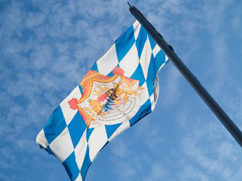 Low angle view of flag against blue sky