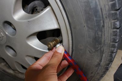 Close-up of human hand holding car