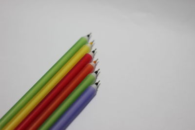 Close-up of multi colored pencils against white background