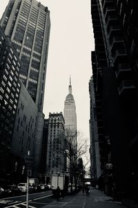 View of city street and buildings against sky