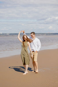 A couple of a man and a woman are dancing on the beach.  date and picnic in nature