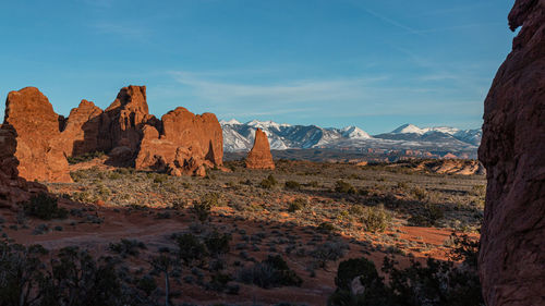Stunningly scenic sandstone rock scenery formations and white snow capped mountains in the distance