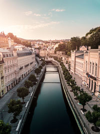 High angle view of canal amidst buildings in city