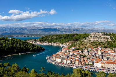 High angle view of river and town against sky