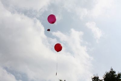 Low angle view of balloons against sky