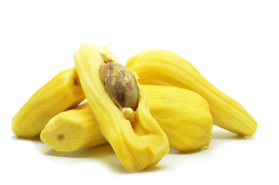 Close-up of yellow slices over white background