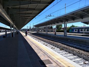 Train at railroad station against clear sky