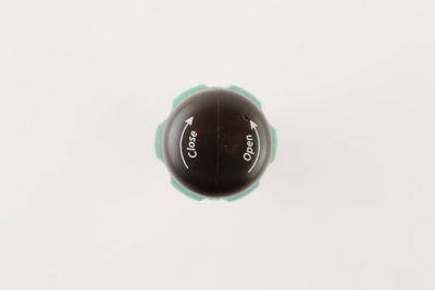Close-up of wineglass against white background