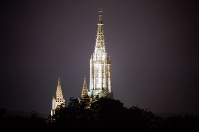 Low angle view of illuminated building against sky at night