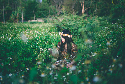 Woman on field by trees