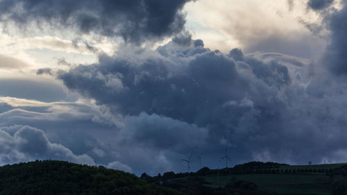 Low angle view of storm clouds over land