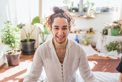 Portrait of smiling young woman sitting at spa