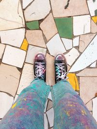 Low section of woman standing on tiled floor