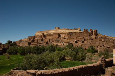 Low angle view of old ruins against clear blue sky