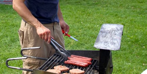 Man standing on barbecue grill