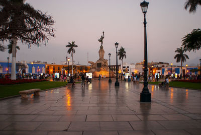 Panoramic view of statue in city against sky