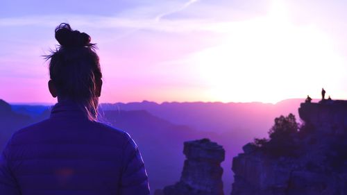 Rear view of woman at grand canyon national park during sunrise