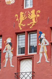 Knight and lion ornaments on the red facade of the town hall in bad muenstereifel, germany