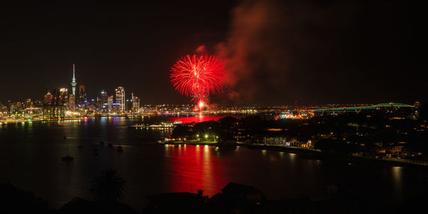 Firework display over city at night