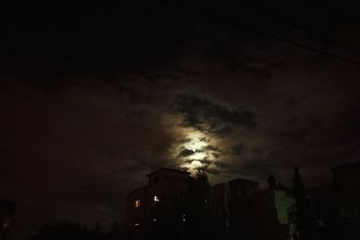 Low angle view of silhouette trees against sky at night