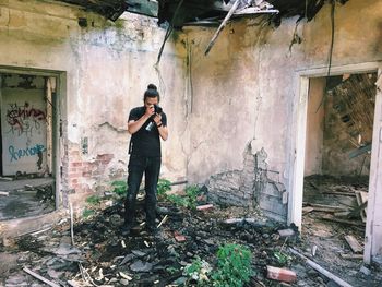 Young man photographing in abandoned house