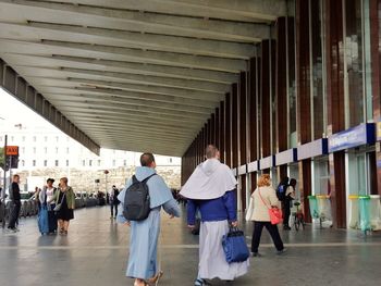 Rear view of people walking in building