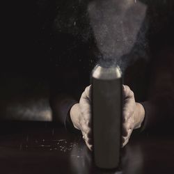 Midsection of man holding book in darkroom
