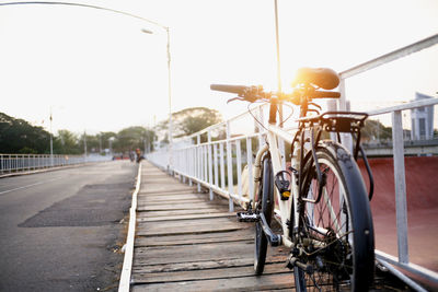 Bicycle parked on road against sky